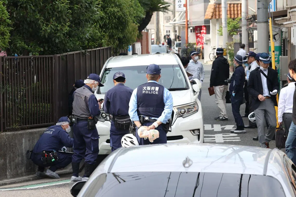 Police officers investigate the scene in Osaka's Nishinari district on May 1, 2025, after a man was arrested after allegedly ploughing his car into seven schoolchildren in a suspected deliberate attack, local media said. (Photo by JIJI PRESS / AFP) / Japan OUT