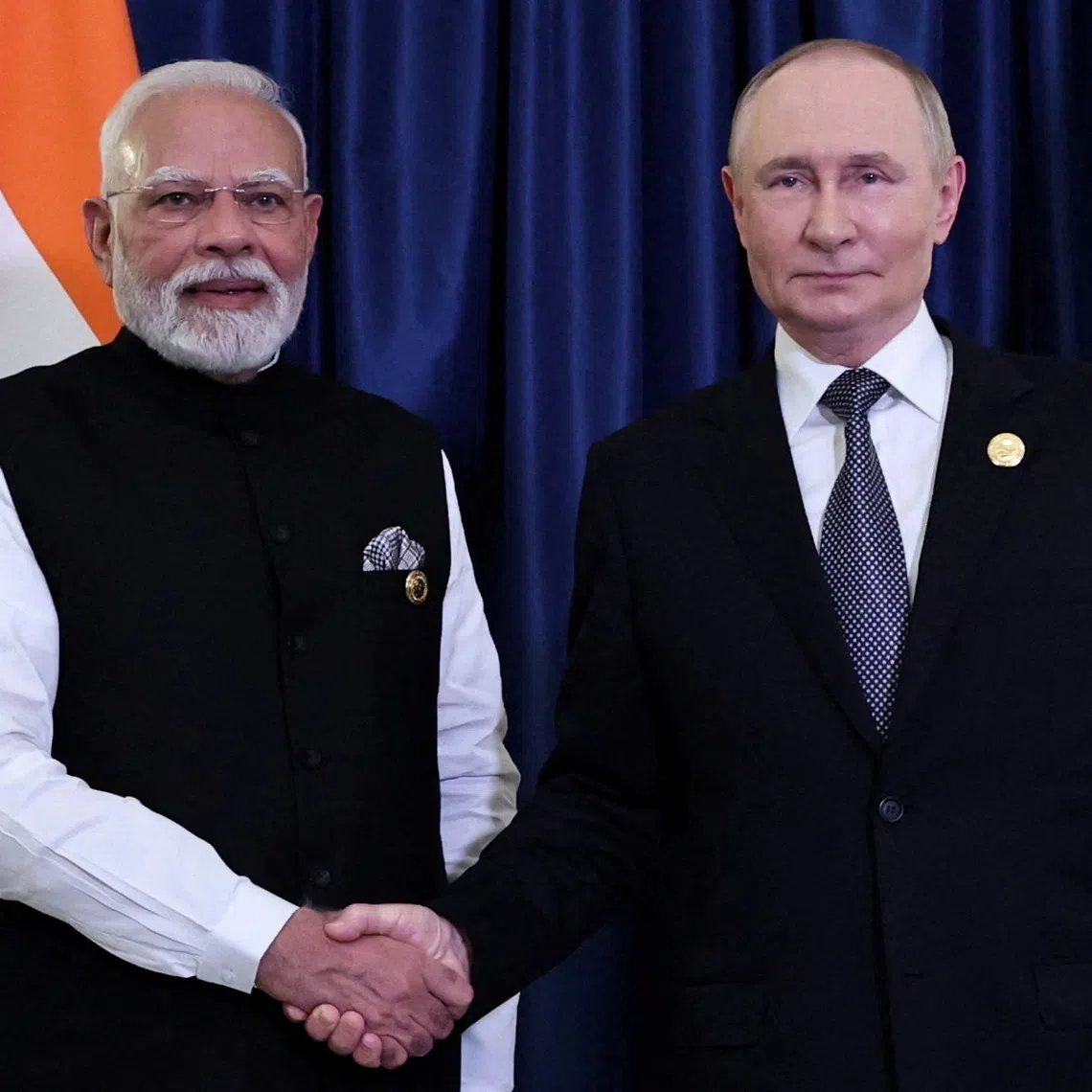 FILE PHOTO: Russian President Vladimir Putin and Indian Prime Minister Narendra Modi shake hands during a meeting on the sidelines of the Shanghai Cooperation Organisation (SCO) summit in Tianjin, China, September 1, 2025. Sputnik/Alexander Kazakov/Pool via REUTERS/File Photo