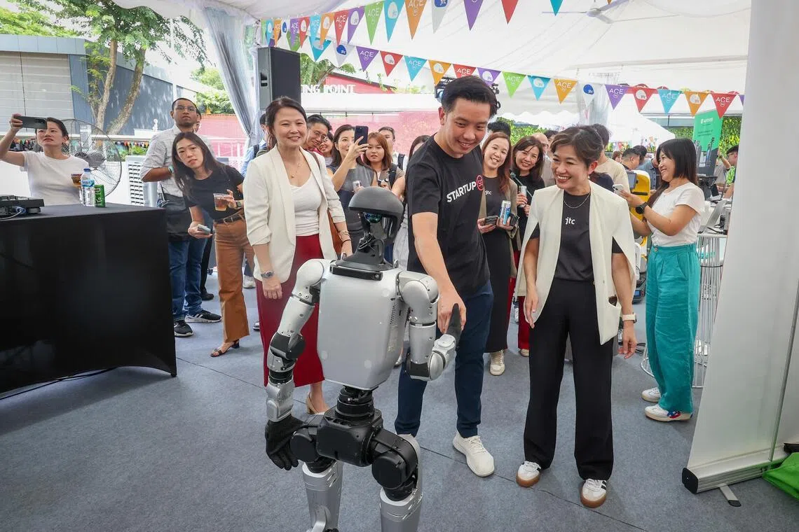ST20260325_202622000988/bnjtc/Benjamin Lim/Jason Quah

(From left) Ms Emily Liew, Assistant Managing Director, Enterprise Singapore; Minister of State Alvin Tan; Ms Jacqueline Poh, JTC CEO interacting with a robot at the LaunchPad @ One-North Carnival, including the reopening of The Meeting Point, on March 25, 2026. ST PHOTO: JASON QUAH
