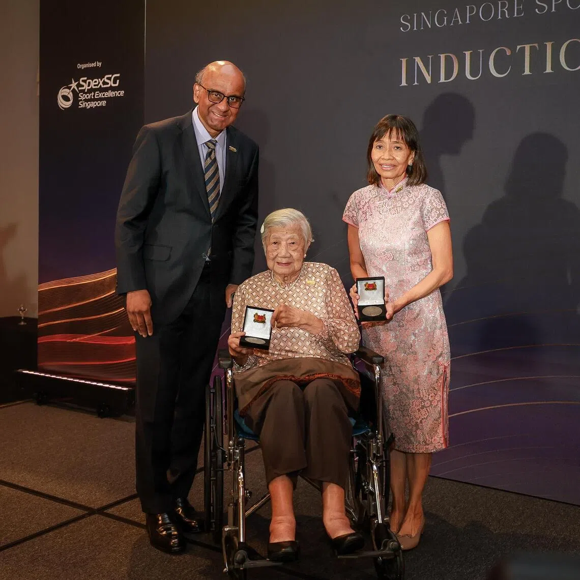 President Tharman Shanmugaratnam pose for a photograph with Singapore Sport Hall of Fame inductees former national hurdler and sprinter Tang Pui Wah (centre) and former national swimmer Tay Chin Joo (right) during the induction ceremony at the Asian Civilisations Museum on July 17.