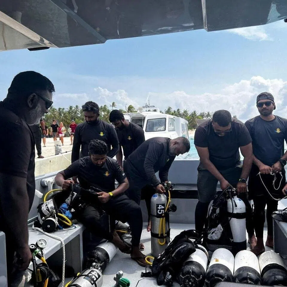 Members of the Maldivian military prepare to search for four Italian divers who drowned inside an underwater cave.