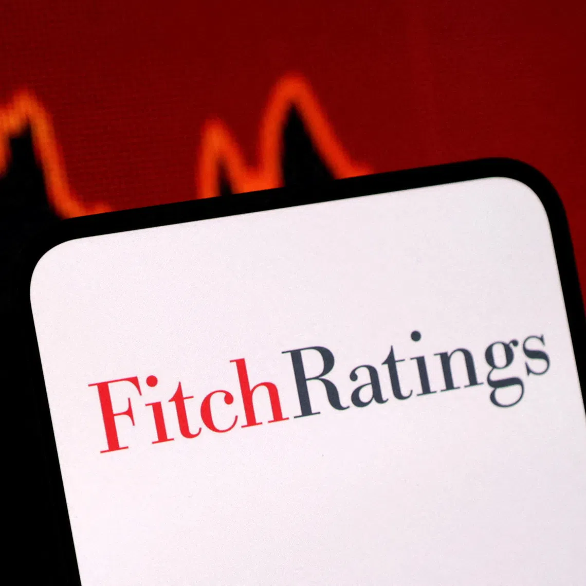 FILE PHOTO: The Fitch Ratings logo and a decreasing stock graph are seen in this illustration taken on January 29, 2025. REUTERS/Dado Ruvic/Illustration/File Photo