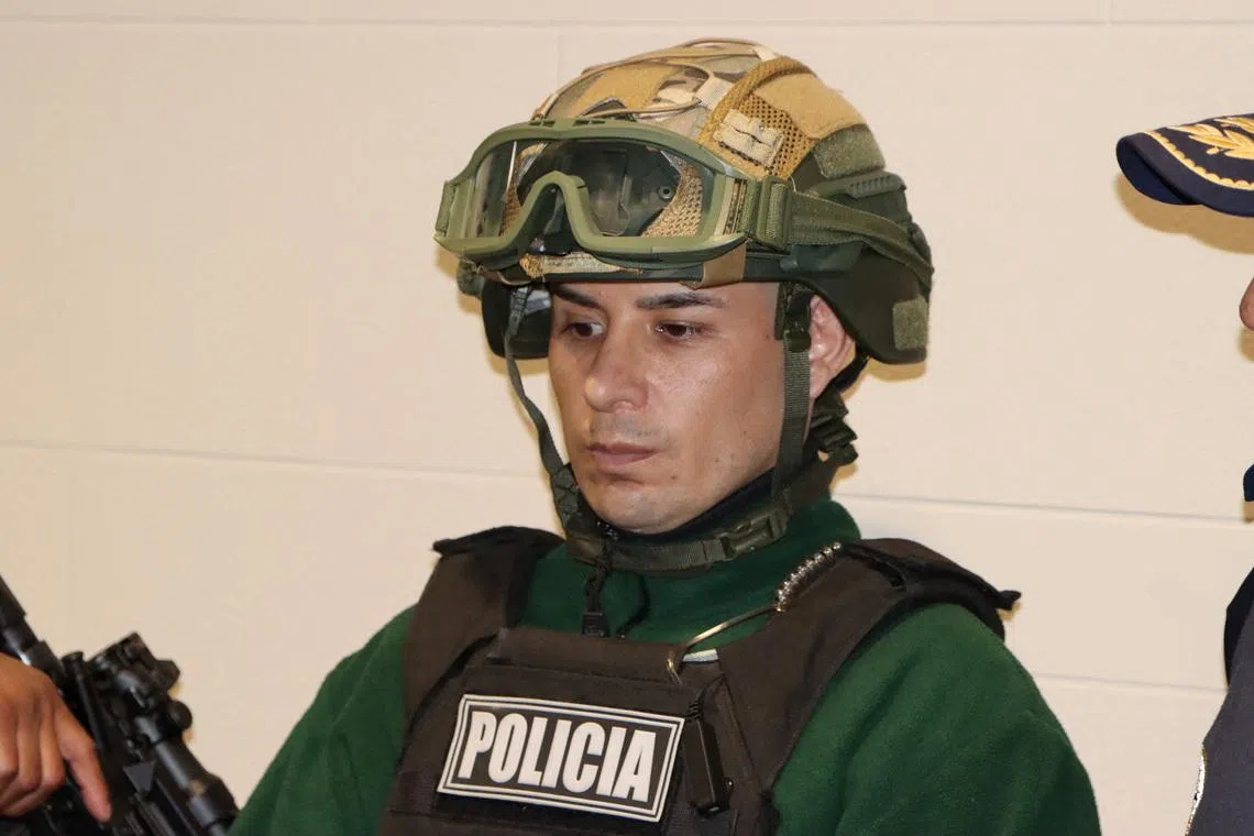 A man identified as Angel Esteban Aguilar, leader of the Ecuadorian criminal group Los Lobos, is photographed after his arrest, who is wanted in connection with the 2023 assassination of Ecuadorean presidential candidate Fernando Villavicencio, at the international airport El Dorado in Bogota, Colombia, March 18, 2026. Colombian Migration/Handout via REUTERS