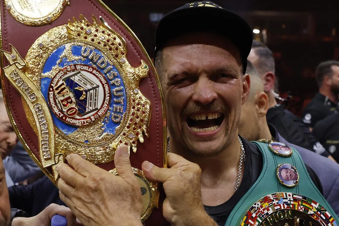 Boxing - Tyson Fury v Oleksandr Usyk - Kingdom Arena, Riyadh, Saudi Arabia - May 19, 2024 Oleksandr Usyk celebrates with the belts after winning the fight to become the undisputed heavyweight world champion Action Images via Reuters/Andrew Couldridge