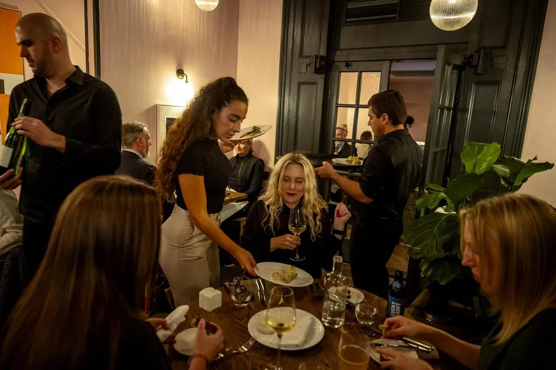 Dinner service at Home Kitchen, a new restaurant in London. In the city’s upmarket Primrose Hill, a Michelin-starred chef is employing people on the edge of homelessness as chefs, wait staff and cocktail makers. 