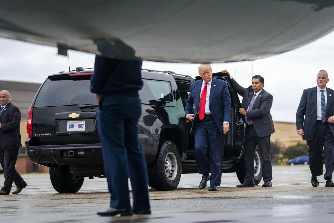 FILE — President Donald Trump exits the presidential S.U.V. with Secret Service agent Bobby Engel, right, at Joint Base Andrews, Md. on Sept. 10, 2020. A former White House aide recalled hearing about Trump lunging at Engel in the vehicle on Jan. 6, 2021, but others have given less detailed accounts. (Doug Mills/The New York Times)