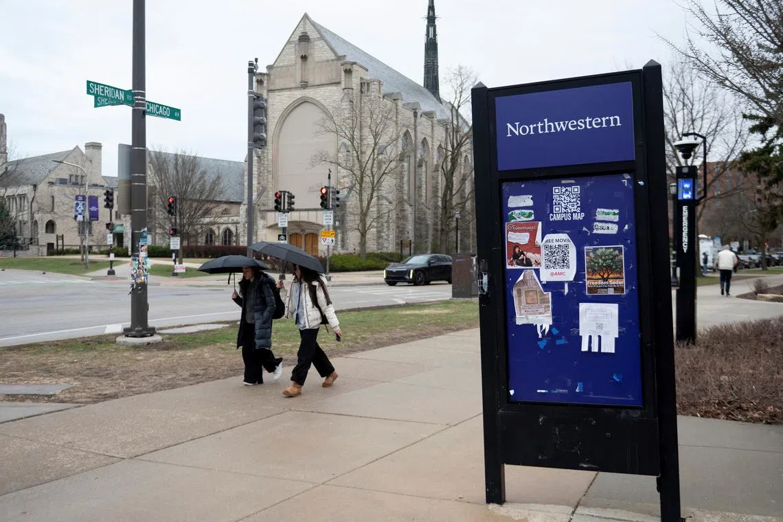 FILE PHOTO: People walk on the campus of Northwestern University, a day after a U.S. official said $790 million in federal funding has been frozen for the University while it investigates the school over civil rights violationsm in Evanston, Illinois U.S. April 9, 2025. REUTERS/Vincent Alban/File photo