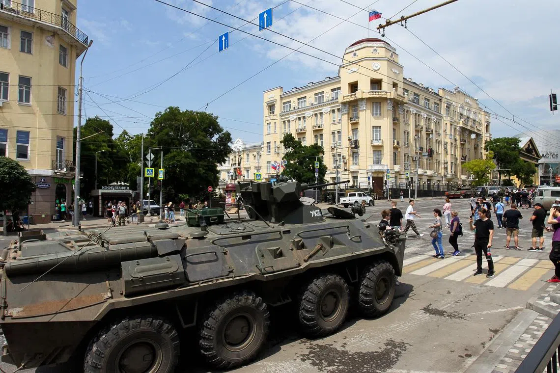 People walking past an armoured personnel carrier on Saturday in the southern Russian city of Rostov-on-Don.