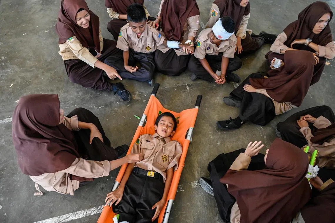 Junior high school students take part in an earthquake and tsunami drill in Banda Aceh on December 23, 2022, ahead of the 18th anniversary of the 2004 Boxing Day tsunami on December 26. 