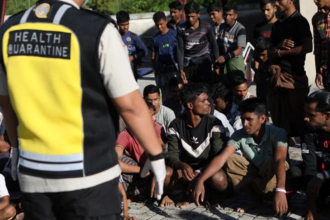 Rohingya refugees line up before receiving  their breakfast at a temporary shelter provided by Aceh local government, in Ladong, Aceh Besar, Indonesia, on Jan 9, 2023.