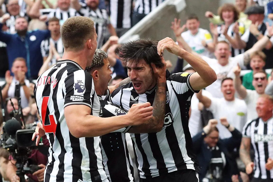 Newcastle United's Sandro Tonali celebrates scoring their first goal on his league debut, with Sven Botman and Bruno Guimaraes.