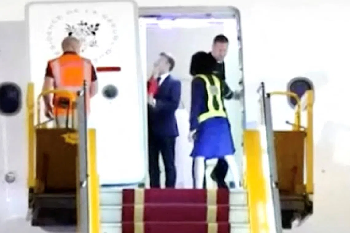 In a video, French President Emmanuel Macron appeared to have been shoved by his wife before he descended from the presidential plane in Hanoi on May 25.