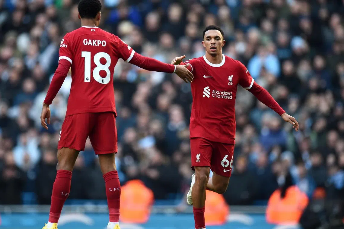 Liverpool's Trent Alexander-Arnold celebrate with Cody Gakpo after scoring the equaliser in the 1-1 English Premier League draw with Manchester City.