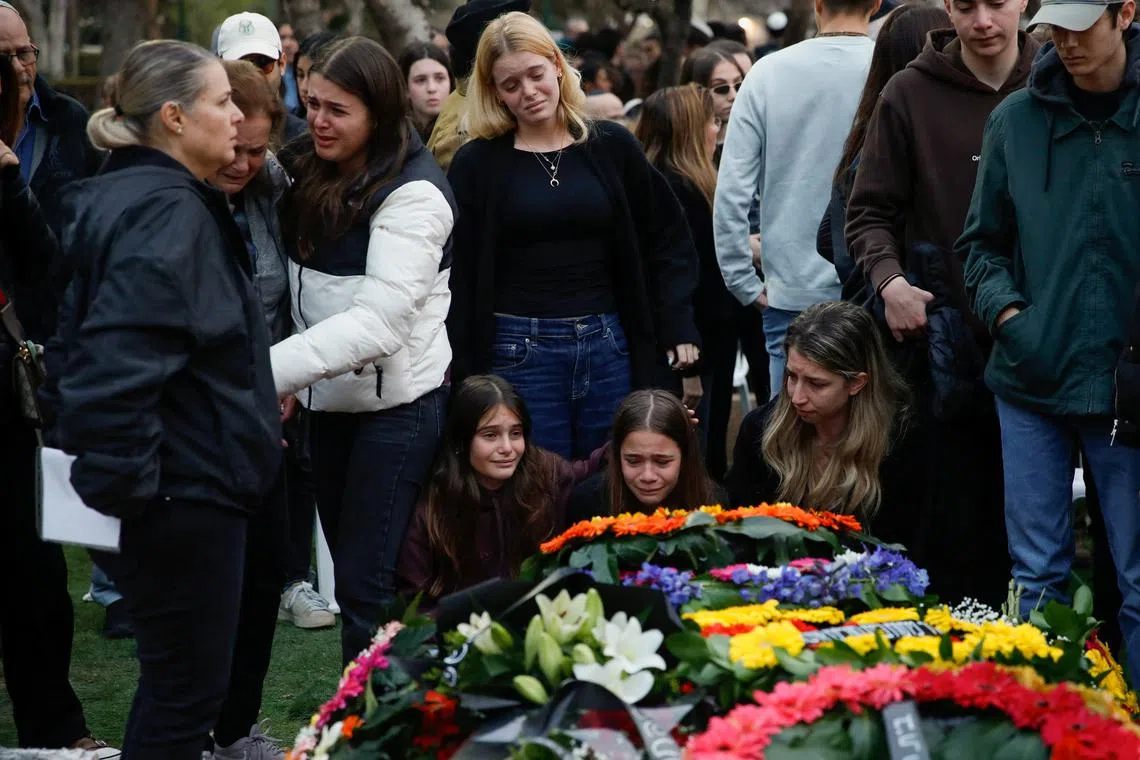 Friends and family mourn Israeli soldier Sergeant first class Adi Eldor who was killed in the southern Gaza Strip, amid the ongoing ground operation of the Israeli army against Palestinian Islamist group Hamas, at his funeral in Haifa, Israel, February 12, 2024. REUTERS/Shir Torem/file photo
