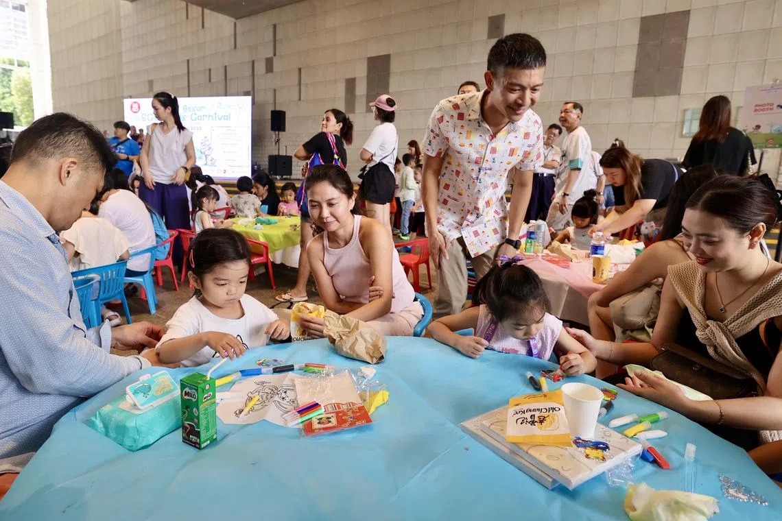 Mr Shawn Loh (standing) meets with Kids Carnival participants at the SG60 Kid's Carnival, at the National Library on April 13.