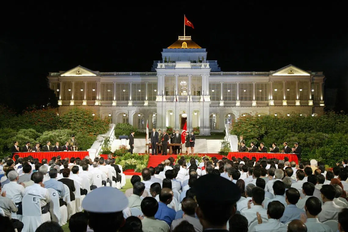 Some 1,400 guests watch the swearing-in ceremony of Mr Lee Hsien Loong’s  Cabinet at the Istana in 2004. 