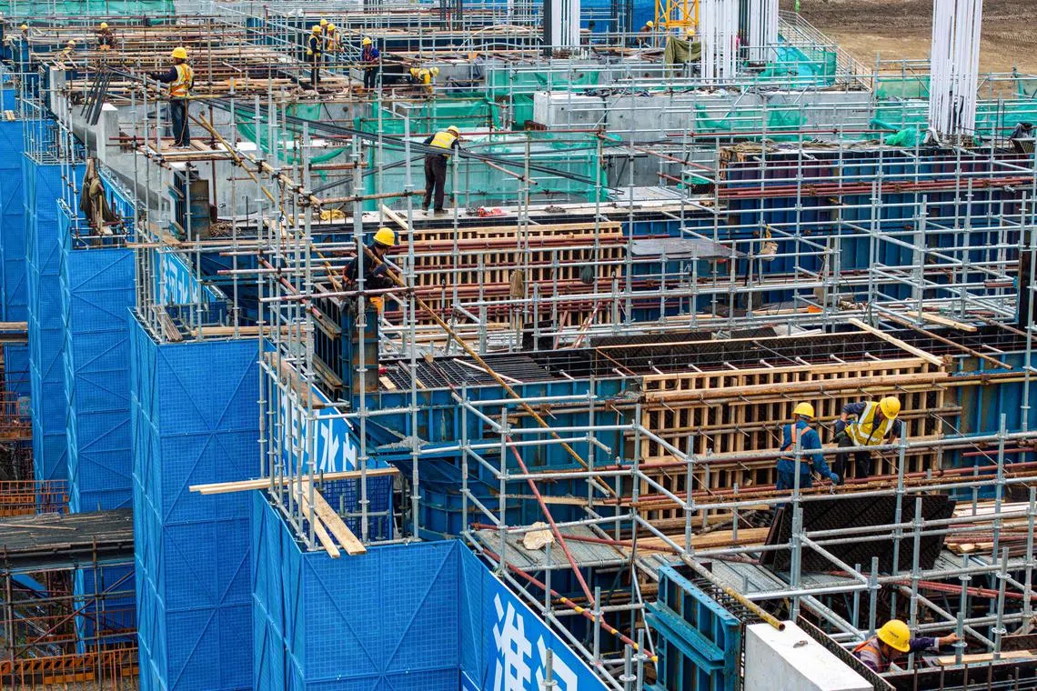 The photo taken on October 13, 2024 shows workers at a construction site of gate station of Huai river estuarial canal, which aims to direct more water to the sea in Huaian, in eastern China's Jiangsu province. (Photo by STRINGER / AFP) / China OUT