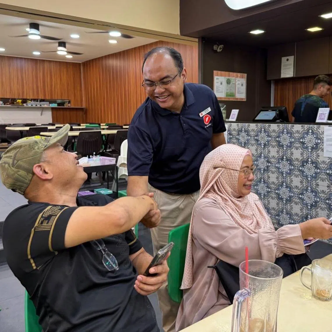 RDU's Holland-Bukit Timah GRC candidates Fazli Talip and Emily Woo on a walkabout near Beauty World MRT station on April 28.