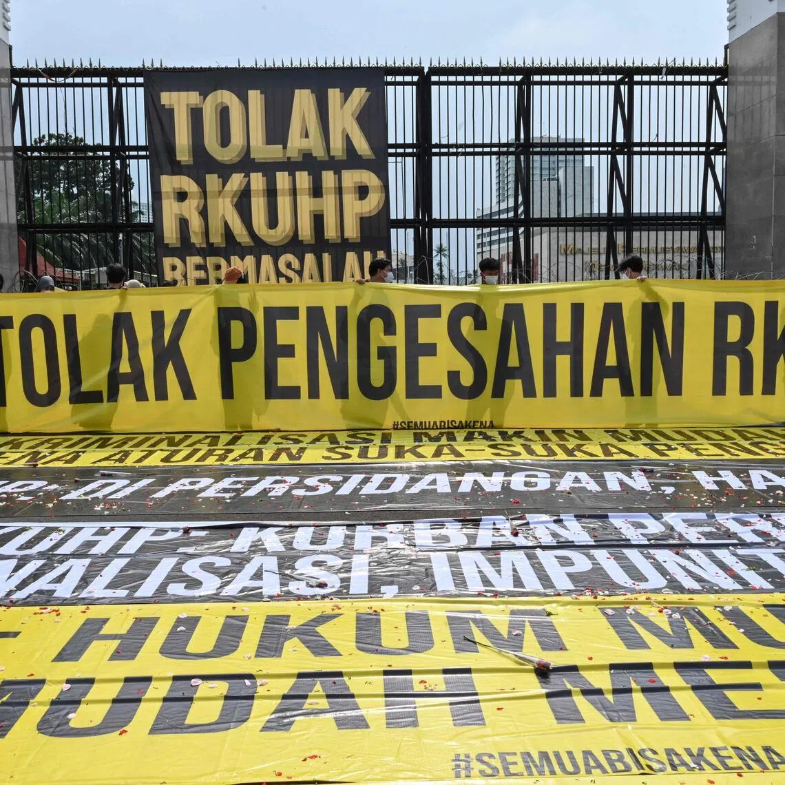Activists protest against the new criminal code outside the parliament building in Jakarta on Dec 5, 2022. The government began enforcing the revised penal code on Jan 2, 2026, three years after then-president Joko Widodo signed it into law. PHOTO: AFP