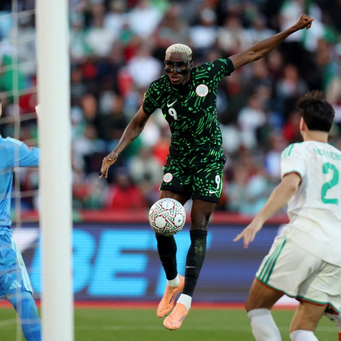 Soccer Football - CAF Africa Cup of Nations - Morocco 2025 - Quarter Final - Algeria v Nigeria - Grand Stadium of Marrakech, Marrakesh, Morocco - January 10, 2026 Nigeria's Victor Osimhen scores their first goal REUTERS/Amr Abdallah Dalsh
