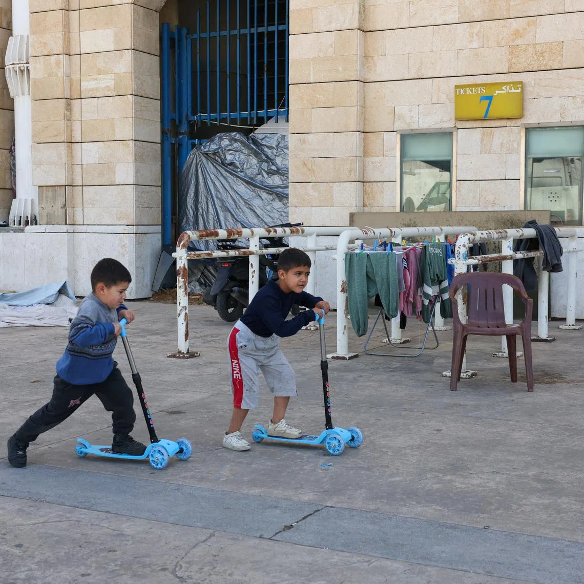 Children play outside Camille Chamoun Sports City stadium, turned into a temporary shelter in Beirut, Lebanon, May 8, 2026. REUTERS/Mohamed Azakir