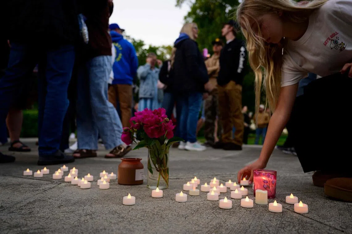 Community members place electric candles near a vase of flowers during a vigil following a fatal chemical storage tank failure on May 26, 2026, in Longview, Washington.