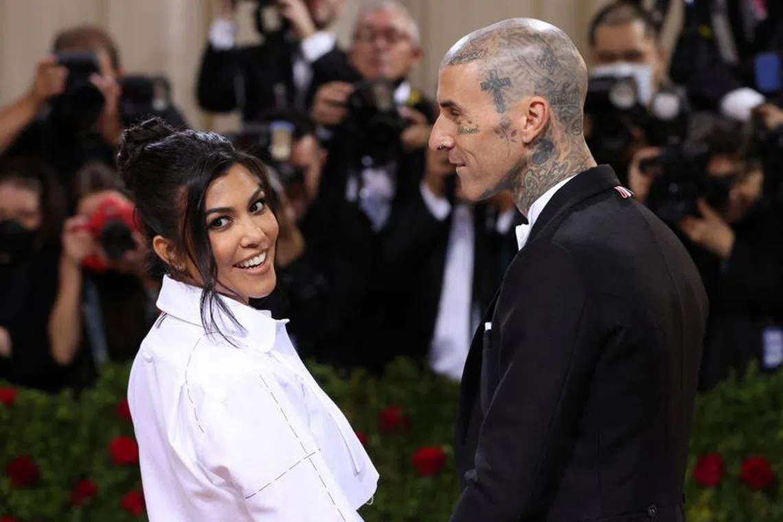 FILE PHOTO: Travis Barker and Kourtney Kardashian arrive at the In America: An Anthology of Fashion themed Met Gala at the Metropolitan Museum of Art in New York City, New York, U.S., May 2, 2022. REUTERS/Andrew Kelly/File Photo