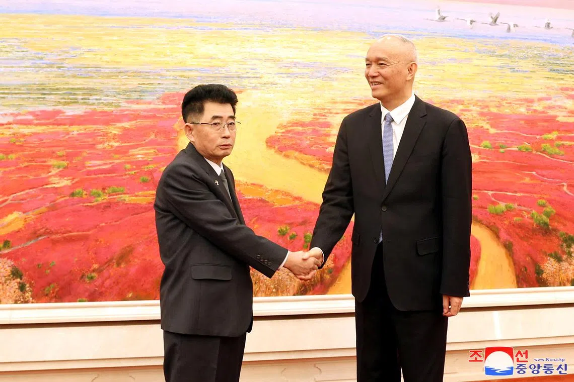 North Korea's Kim Song Nam, an alternate member of the Political Bureau and head of the International Department of the Workers' Party of Korea, and Cai Qi, head of the Secretariat of the Chinese Communist Party, shake hands at the Great Hall of the People in Beijing, China, March 22, 2024. KCNA via REUTERS