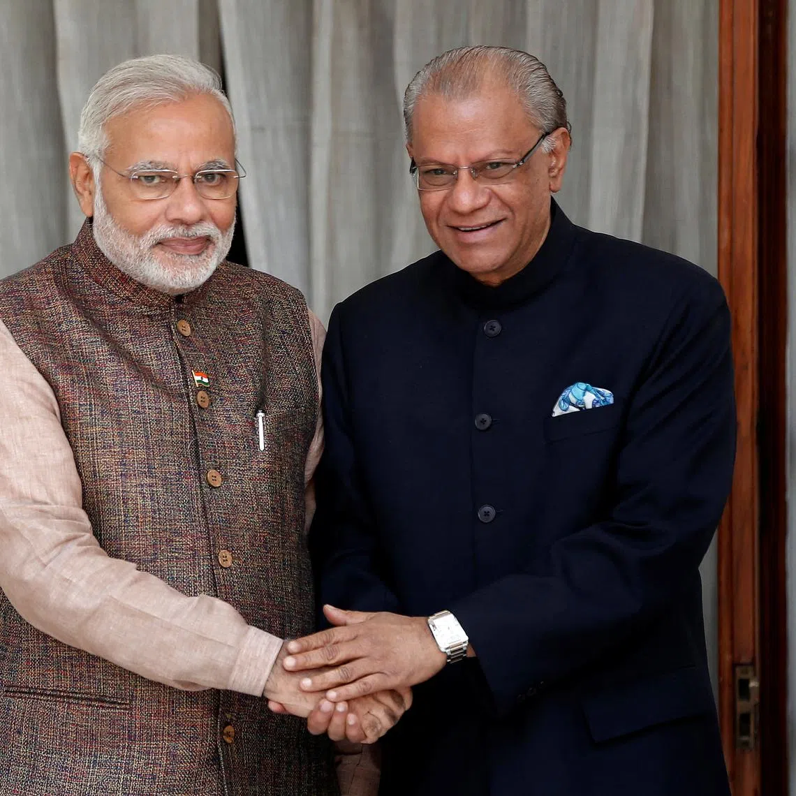 FILE PHOTO: India's Prime Minister Narendra Modi (L) shakes hands with his Mauritian counterpart Navinchandra Ramgoolam before the start of their bilateral meeting in New Delhi May 27, 2014.  REUTERS/Adnan Abidi/File Photo