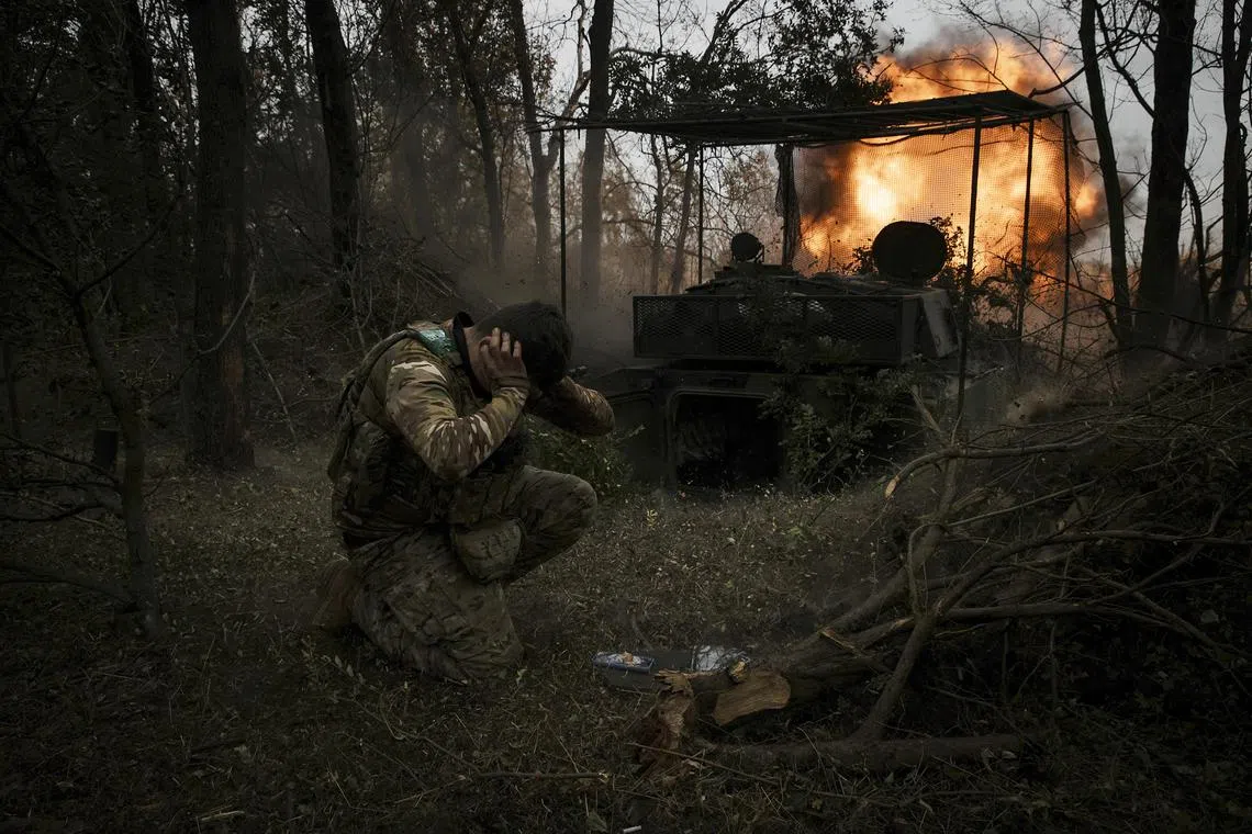 Ukrainian soldiers fire artillery shells at Russian positions in the Pokrovsk district of Ukraine.