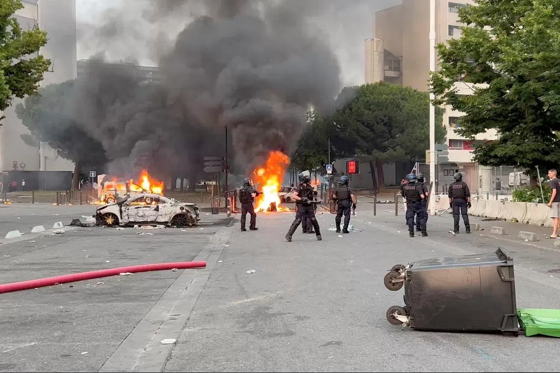Cars and bins were torched in parts of Paris and nationwide overnight, and protesters launched fireworks at riot police.