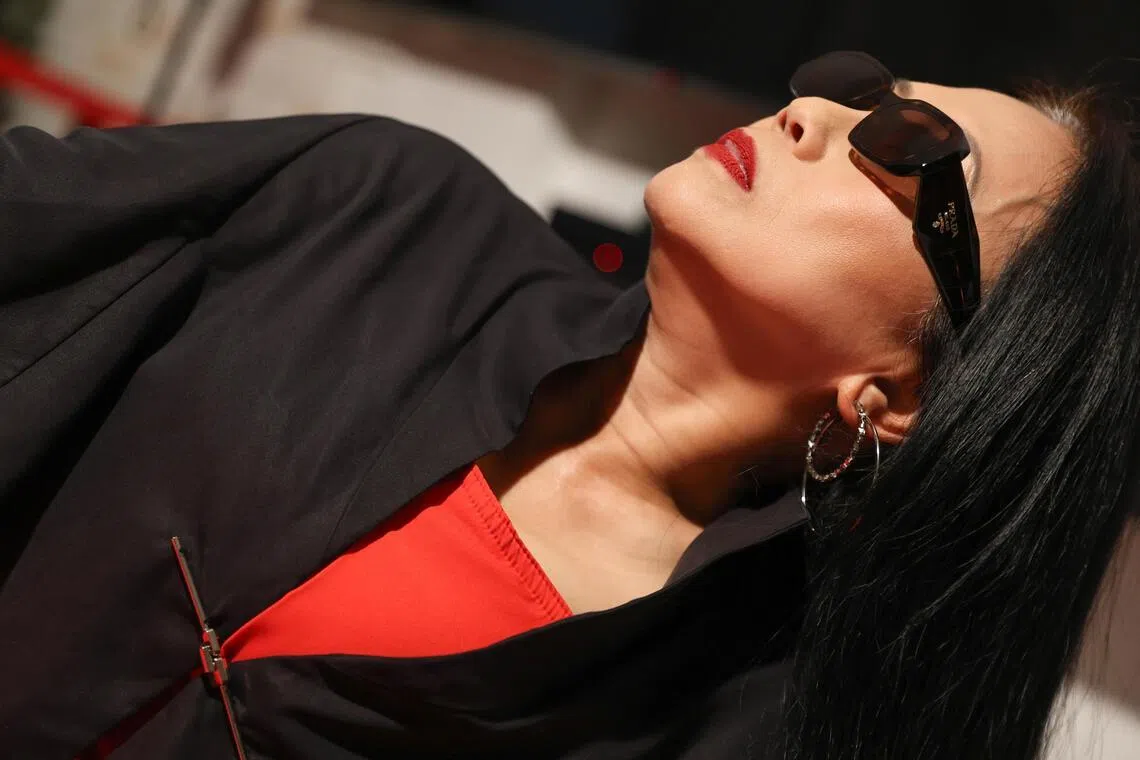 Susie Low styles her outfits with bold accessories, oversized sunglasses and layered pieces.