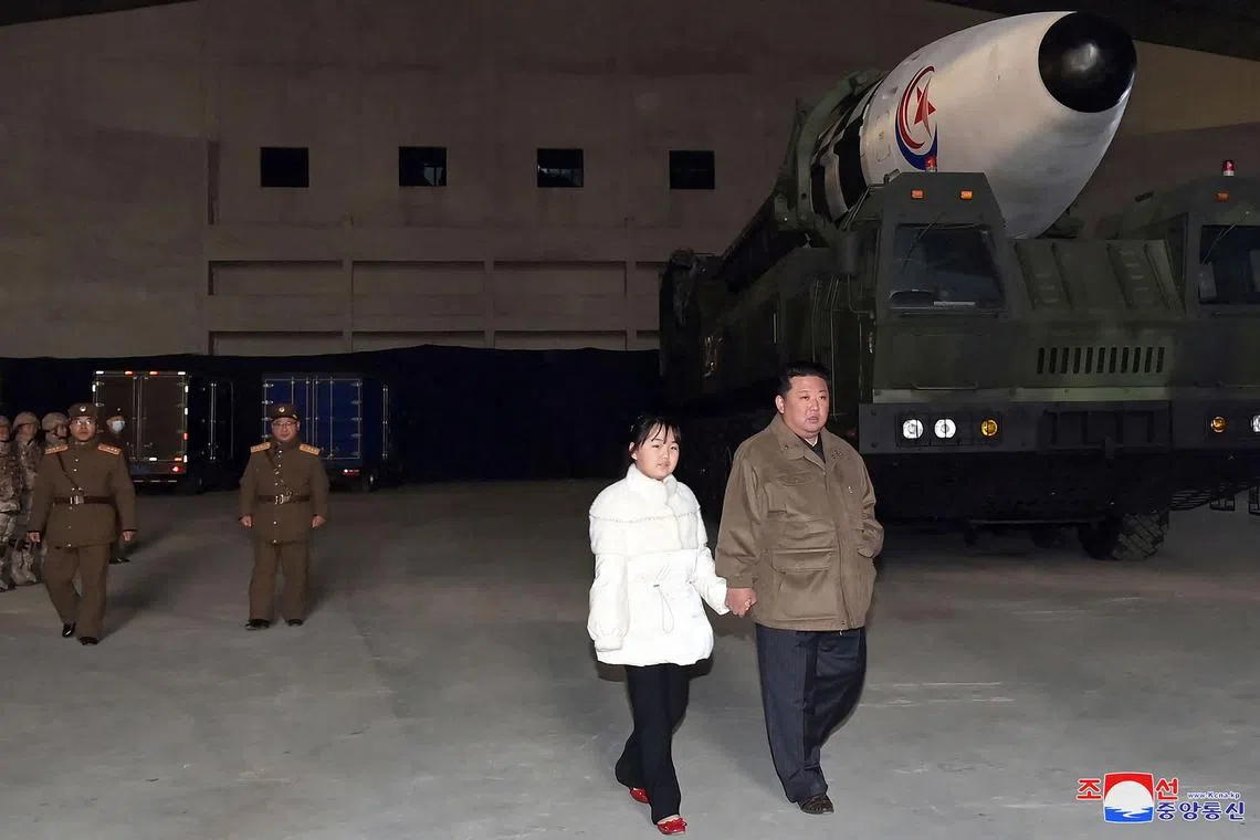 This picture taken on Nov 18, 2022 shows North Korea's leader Kim Jong Un walking with his daughter as he inspects a new intercontinental ballistic missile (ICBM).