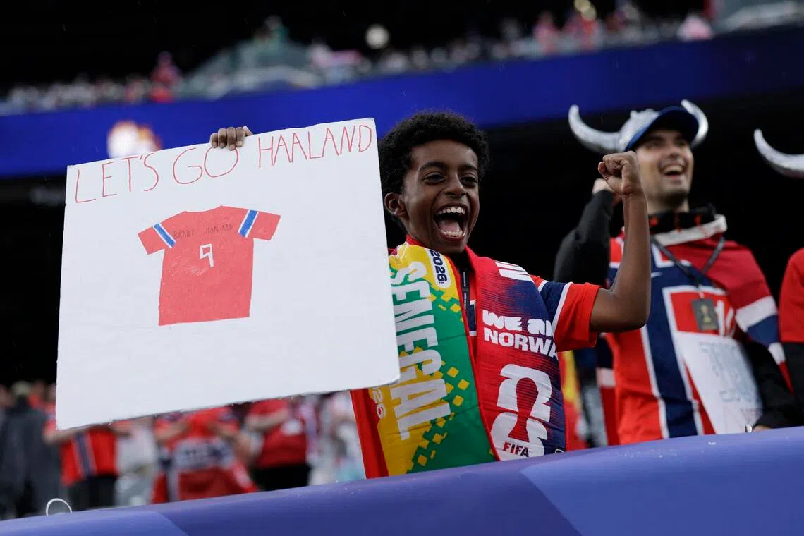 A young fan holding up a sign for Norway’s Erling Haaland inside the stadium before the match on June 22.
