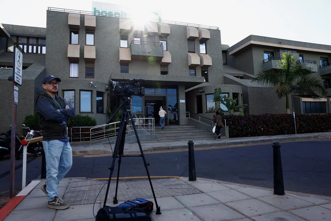 A member of the media works outside the hospital where Norway's King Harald was taken on Tuesday after suffering from an infection and dehydration, according to the royal palace, in Arona, Tenerife island, Spain, February 26, 2026. REUTERS/Borja Suarez
