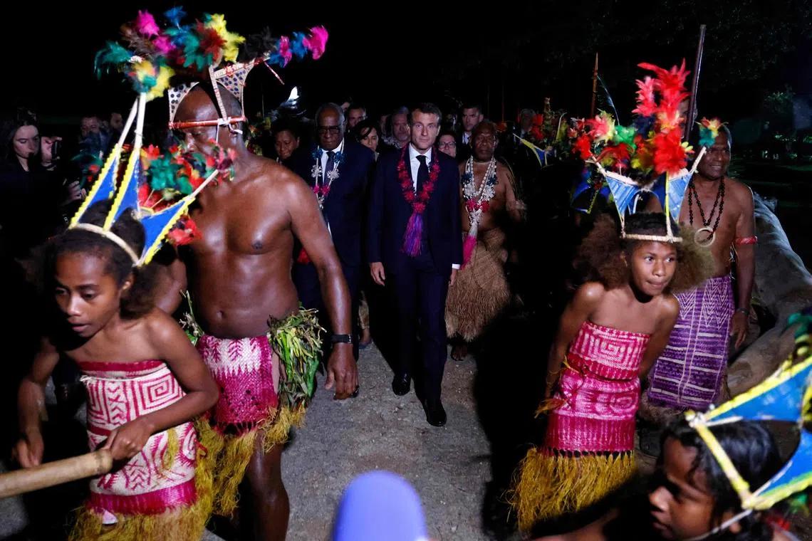 Mr Emmanuel Macron (centre) is the first French president to have set foot on Vanuatu since war leader Charles de Gaulle.