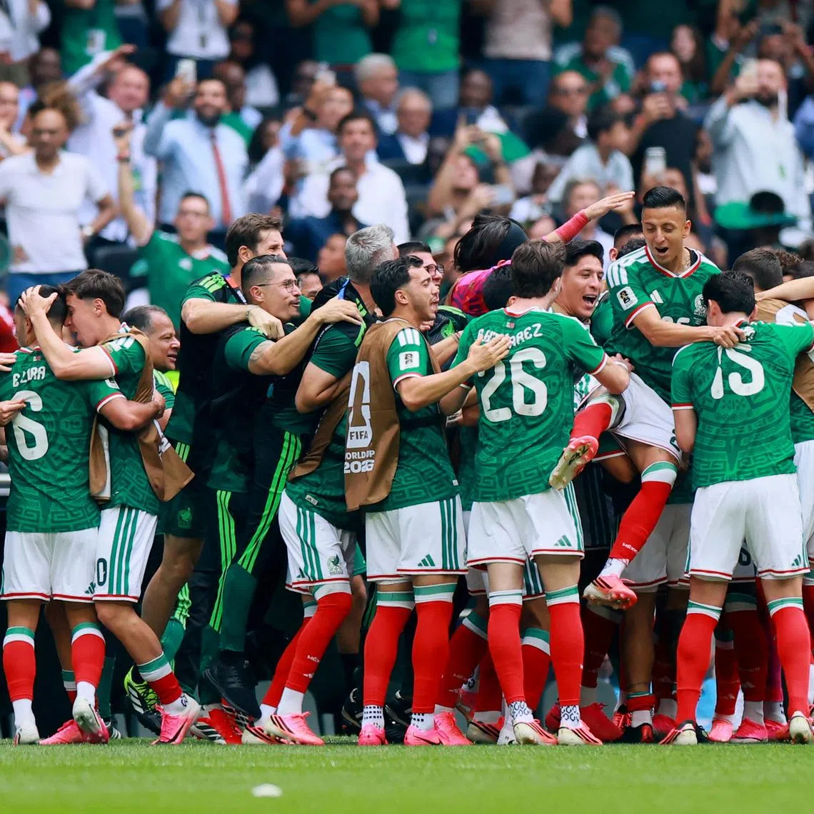 Mexico's Julian Quinones celebrating scoring their first goal with team-mates and coach Javier Aguirre on June 11. 