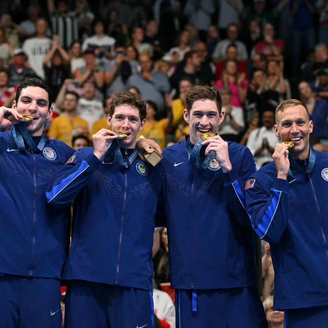 Gold medallists Jack Alexy, Chris Guiliano, Hunter Armstrong and Caeleb Dressel pose with their medals after winning the men's 4x100m freestyle relay.