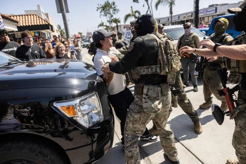  A man detained as clashes break out after US Customs and Border Protection officers attempted to raid a store in Bell, south of Los Angeles, California, on June 20.