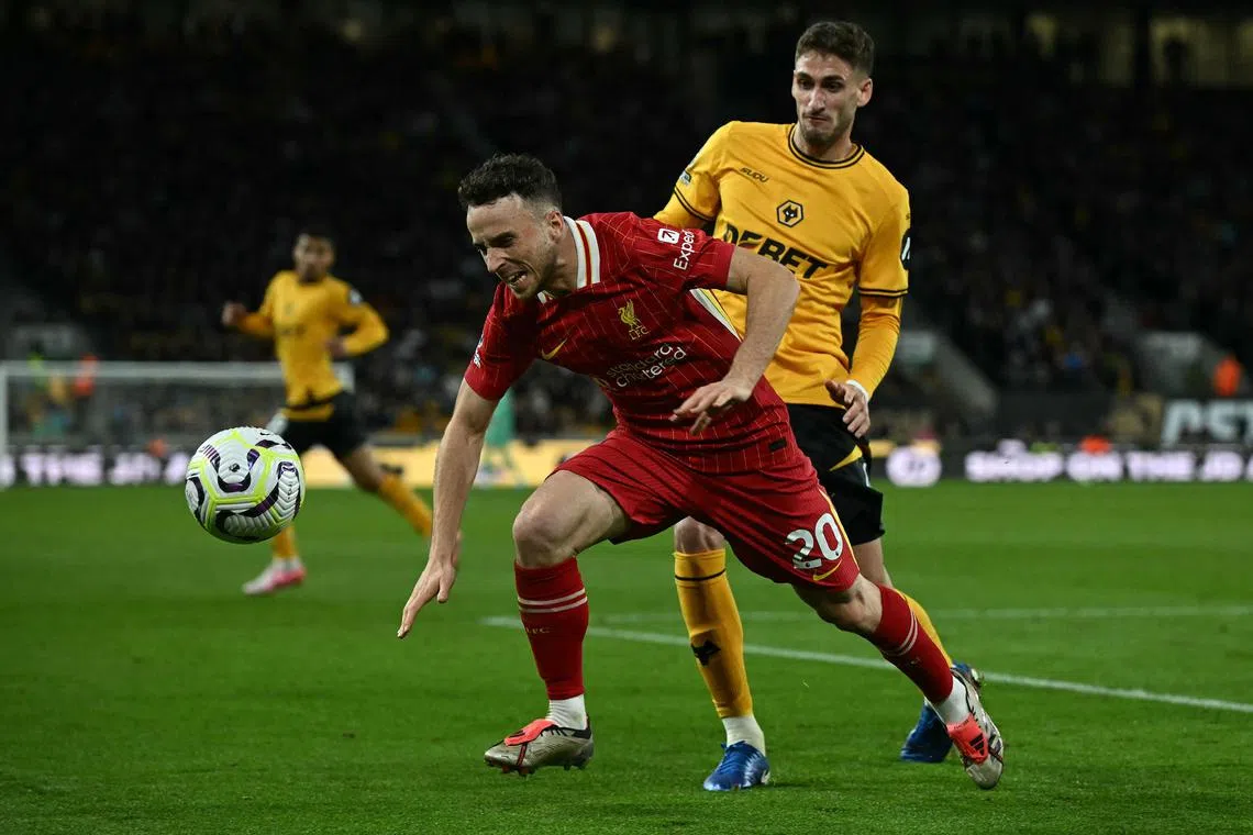 Wolverhampton Wanderers' Uruguayan defender Santiago Bueno (right) fouling Liverpool's Portuguese striker Diogo Jota during the English Premier League football match between Wolverhampton Wanderers and Liverpool at the Molineux stadium on Sept 28.