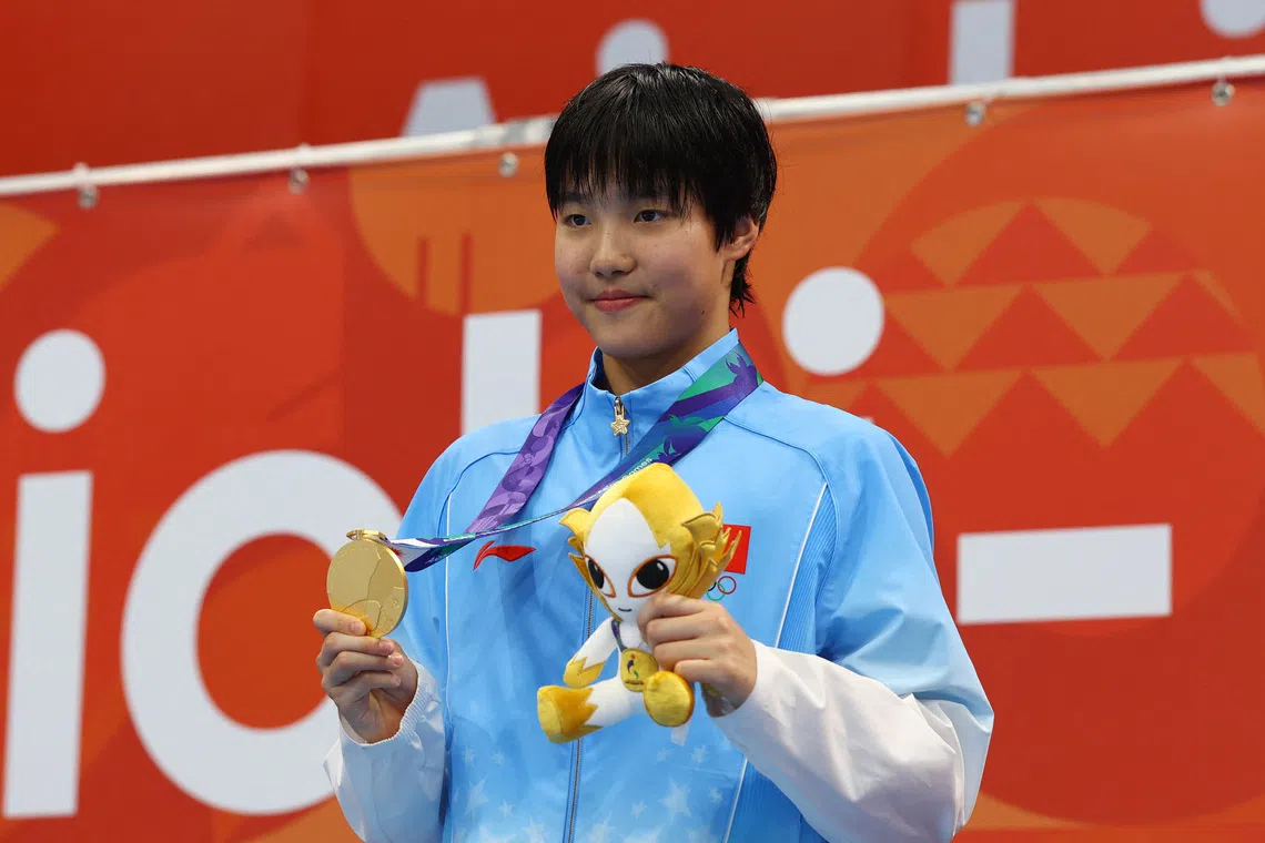 China’s Zidi Yu celebrates on the podium after winning the women’s 200m individual medley final at the Asian Games.