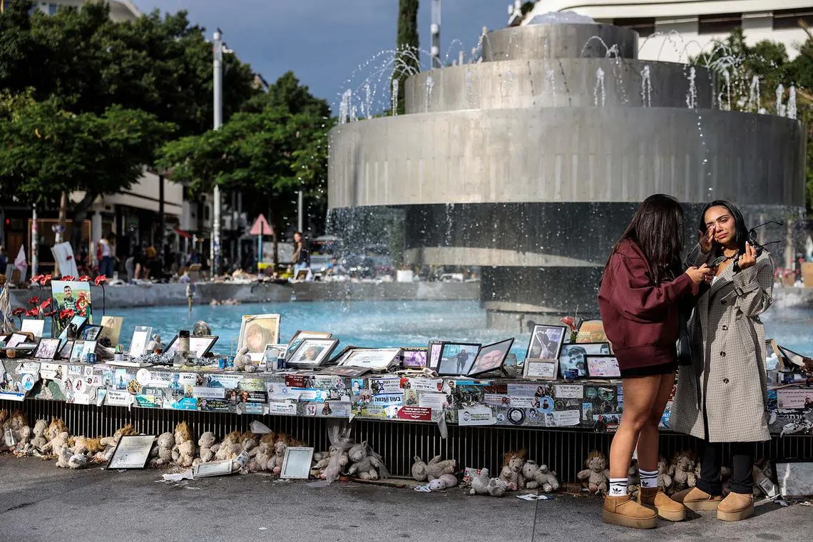 Israeli women standing at Dizengoff Square where pictures and memorabilia of hostages kidnapped during the deadly Oct 7, 2023 attack on Israel are displayed, amid the ongoing conflict in Gaza between Israel and Hamas, in Tel Aviv, Israel, Nov 20, 2024. 