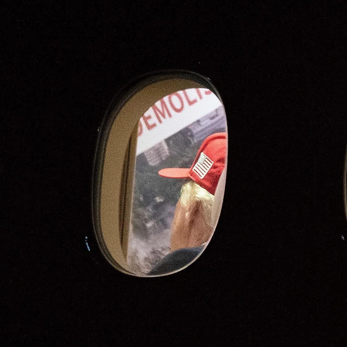 US President Donald Trump is seen aboard Air Force One examining a large Kennedy Center printout after landing at Joint Base Andrews, Maryland on Sept 16, 2026.