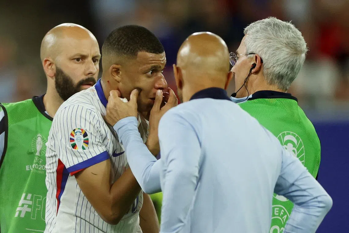 Soccer Football - Euro 2024 - Group D - Austria v France - Dusseldorf Arena, Dusseldorf, Germany - June 17, 2024 France's Kylian Mbappe receives medical attention after sustaining an injury REUTERS/Thilo Schmuelgen