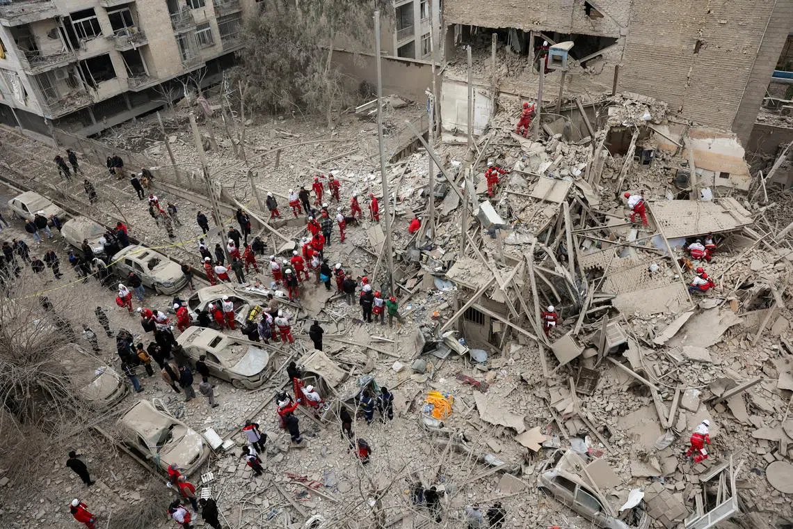 Emergency personnel work at the site of a strike on a residential building, amid the U.S.-Israeli conflict with Iran, in Tehran, Iran, March 16, 2026. Majid Asgaripour/WANA (West Asia News Agency) via REUTERS