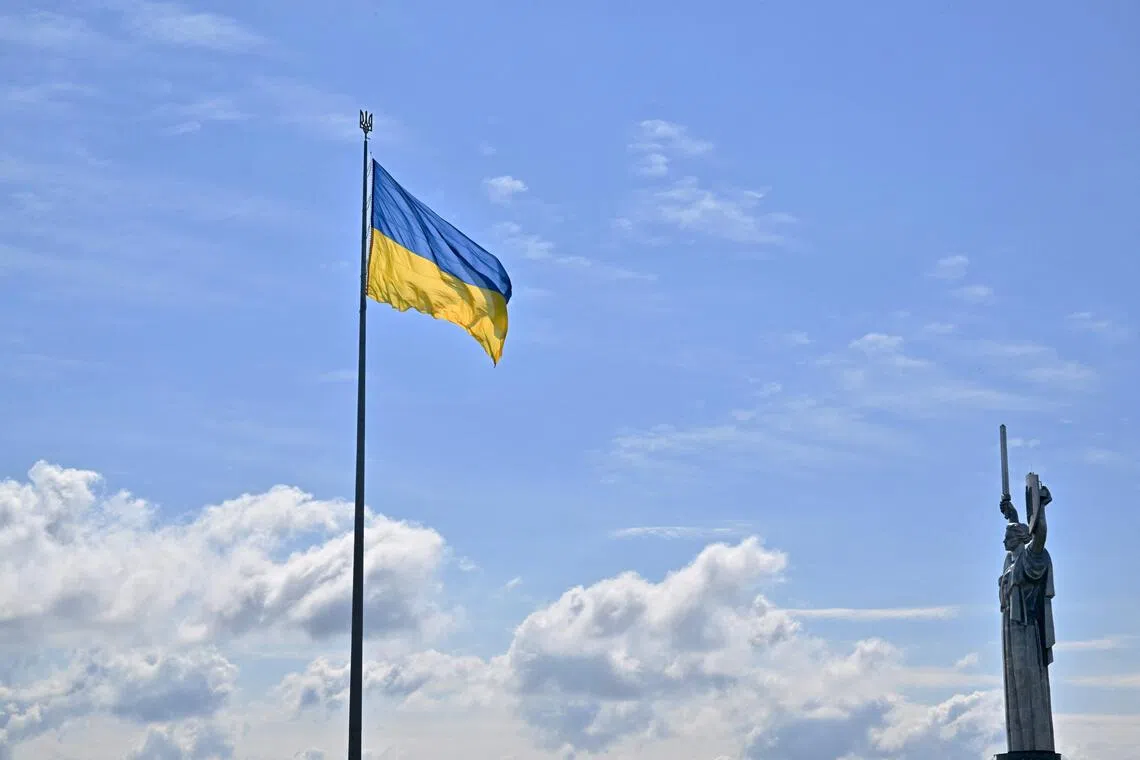 The Ukrainian flag and the Motherland monument (right) in Kyiv on Aug 23, a day before Ukraine's Independence Day.