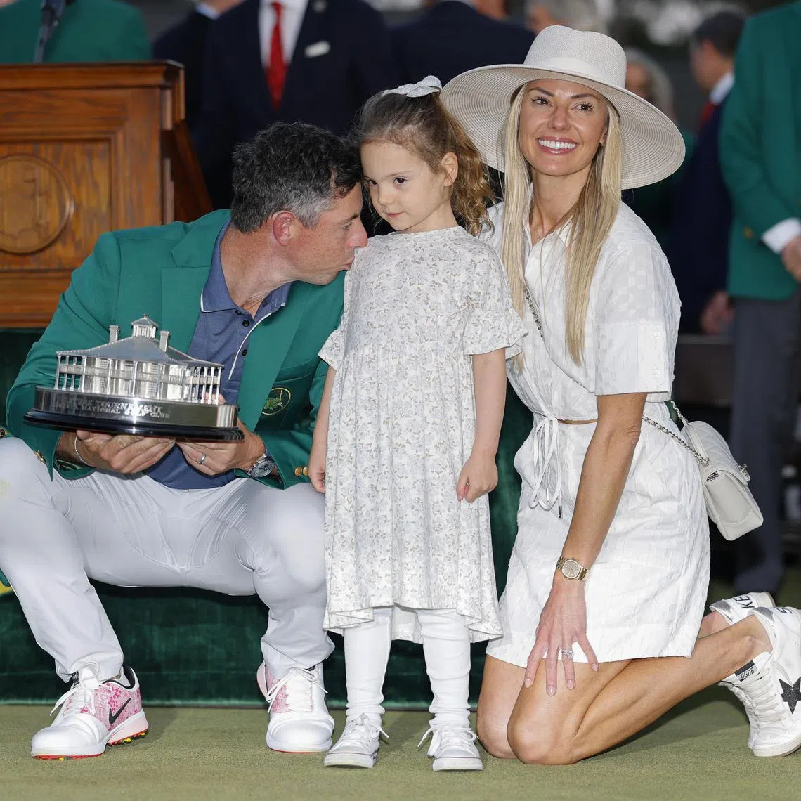 Rory McIlroy posing with his daughter Poppy and wife Erica after winning the Masters at the Augusta National Golf Club on April 13. 