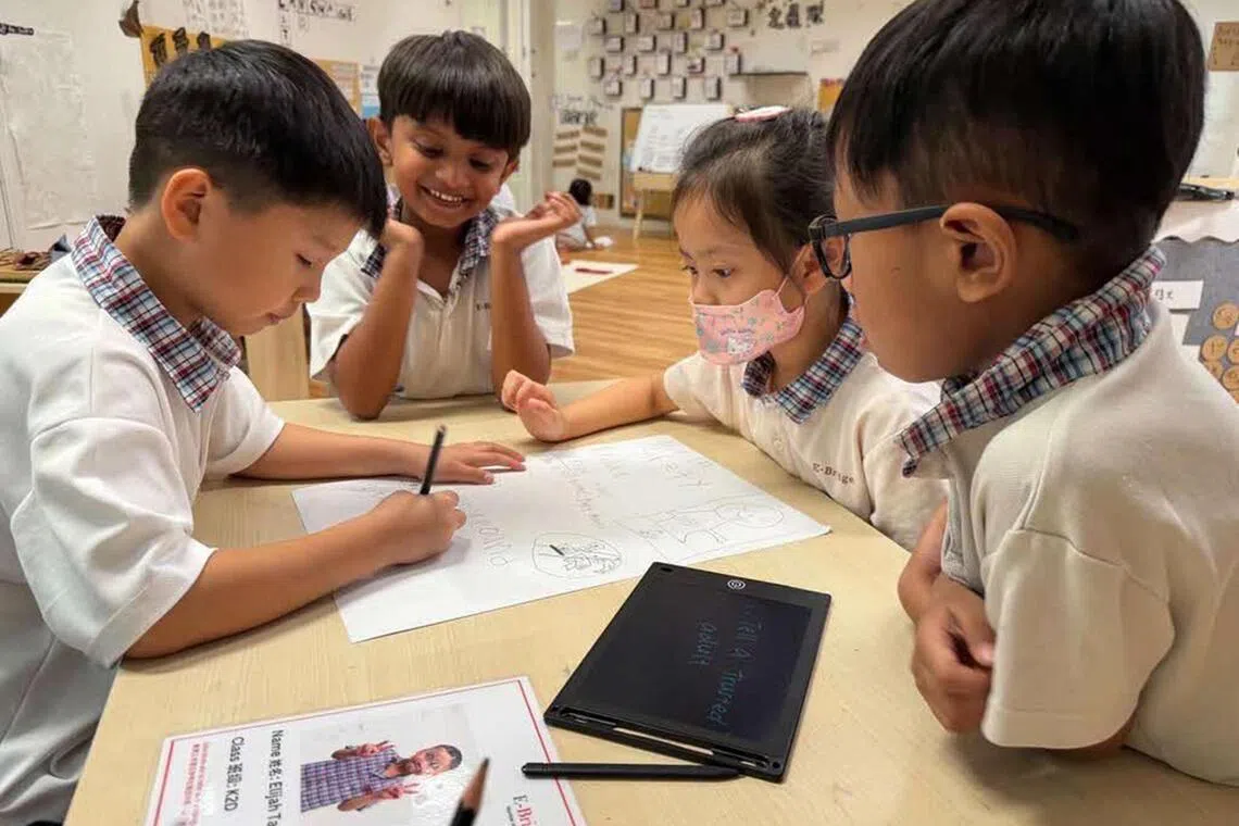 Kindergarten children at E-Bridge Pre-School brainstorming and creating a poster to encourage and advocate online safety.