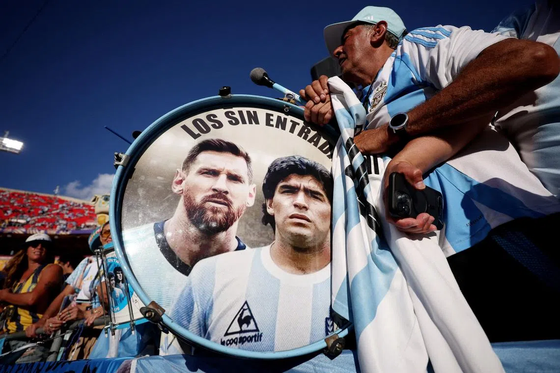 FILE PHOTO: Soccer Football - FIFA World Cup 2026 - Quarter Final - Argentina v Switzerland - Kansas City Stadium, Kansas City, Missouri, U.S. - July 11, 2026 Argentina fans play drums displaying Lionel Messi and Diego Maradona inside the stadium before the match REUTERS/Lee Smith/File Photo