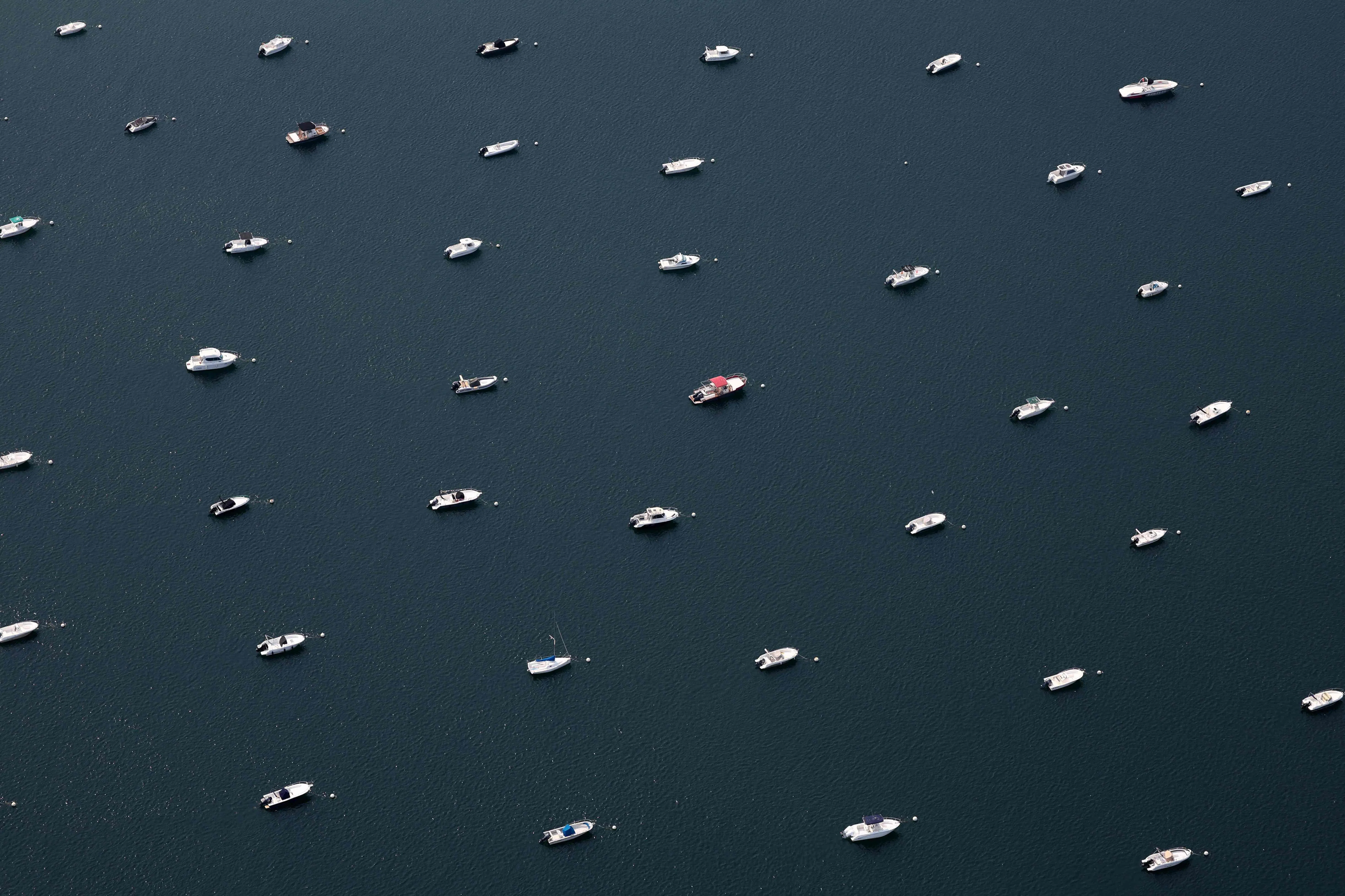 TOPSHOT - This aerial photograph shows boats moored in the Bassin d'Arcachon, south-western France, on July 24, 2026. (Photo by ROMAIN PERROCHEAU / AFP)